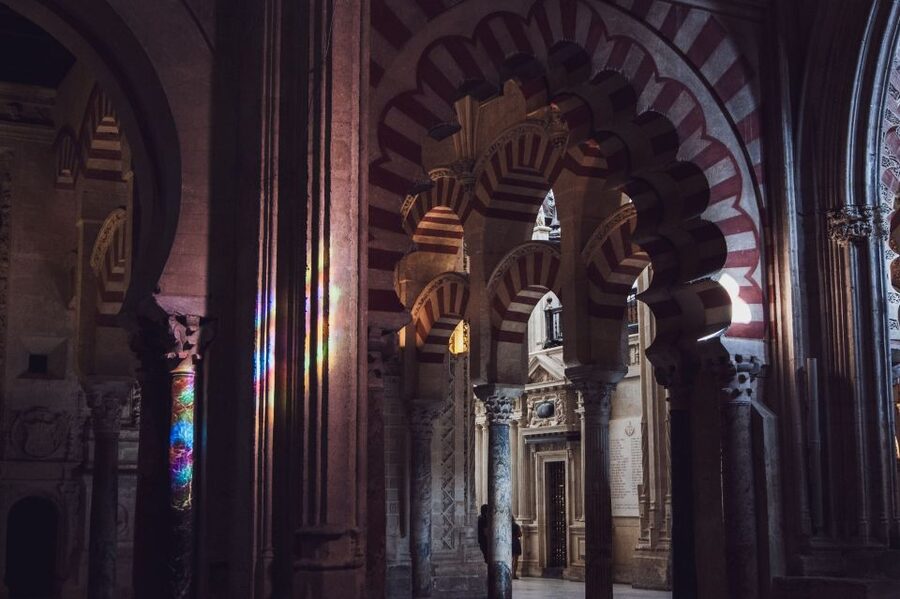 From Malaga: Cordoba Day Trip and Mosque-Cathedral - Crossing the Roman Bridge beside the old city