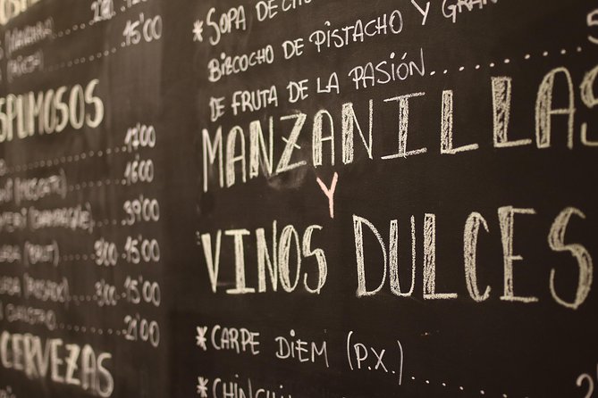 Malaga Wine & Tapas Small Group Guided Tour - Iberian ham inside a traditional ultramarinos