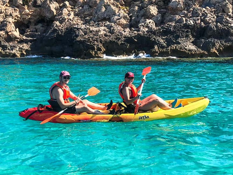 Mallorca: Sea Cave Kayaking Tour with Snorkeling and a Snack - Sea caves, rock entries, and clear water