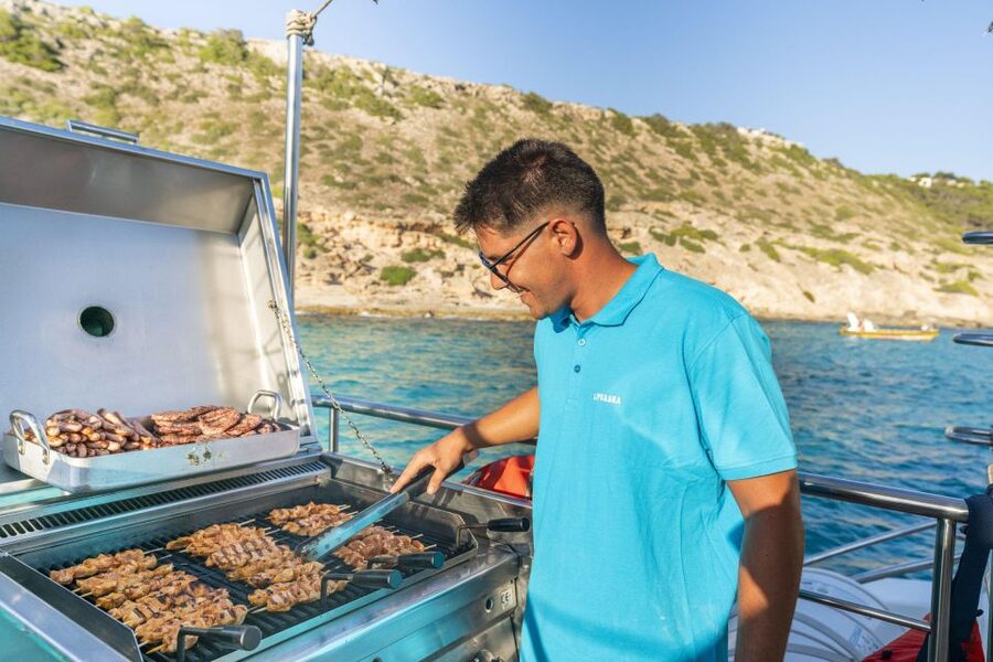 S'Arenal: Sunset Catamaran Cruise with BBQ - Sailing toward Cap Enderrocat and Cala Vella