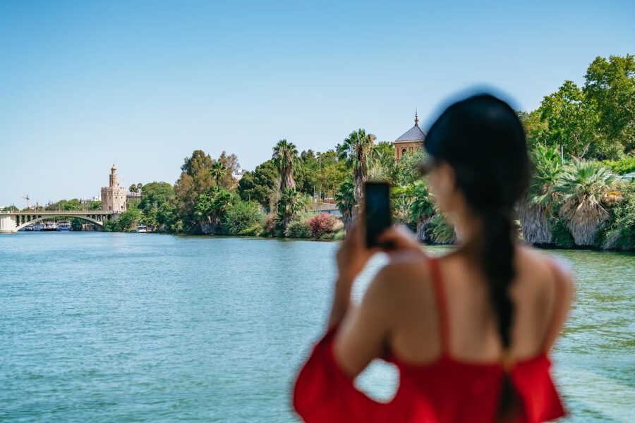 Seville: 1-Hour Guadalquivir River Sightseeing Eco Cruise - Old towers beside newer Seville