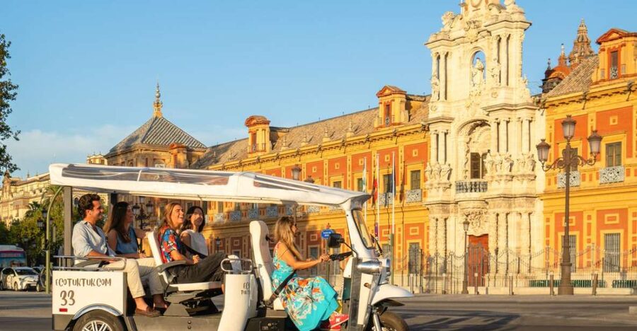 Seville: Private City Tour by Eco Tuk Tuk - Crossing Triana Bridge into Seville’s river districts