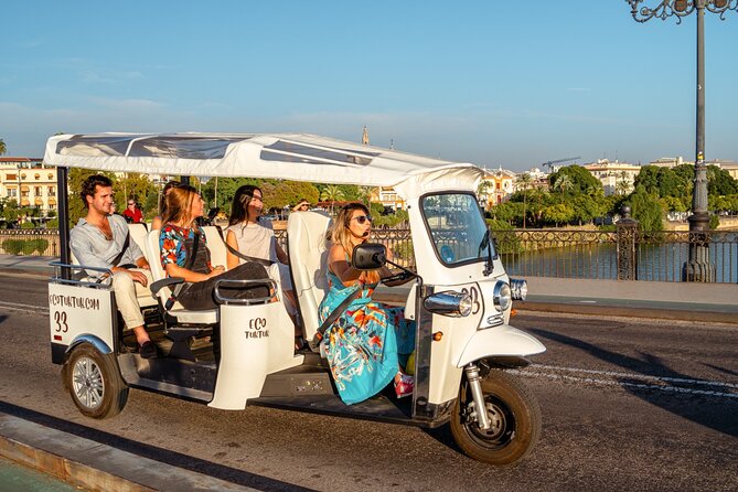 Tour Welcome Seville with Local Guide in Eco Tuk Tuk Private - Crossing the Triana Bridge into a different Seville
